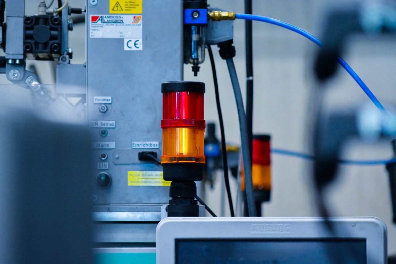 The Art of Drawing Readers In: Your attractive post title goes here Detailed view of automated machinery with warning signals in an industrial setting.